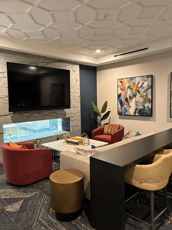 a media lounge with a table and chairs and a television  at The Clearing at ONE28, Kansas, 66062